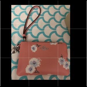 A cute and classy light pink coach wristlet perfect for you!